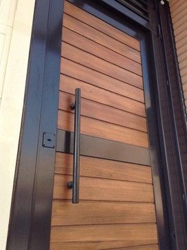 a wooden door with metal handle on it