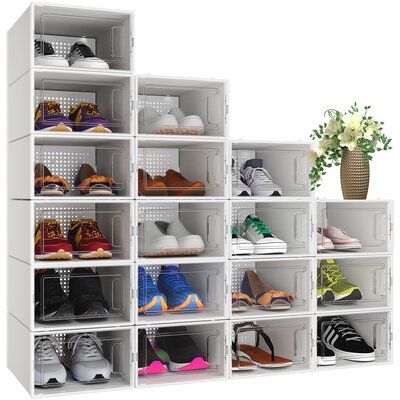 a white shelf filled with lots of shoes