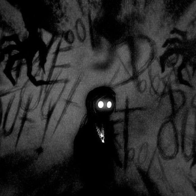 a black and white photo of a person with a flashlight in their hand, standing next to graffiti