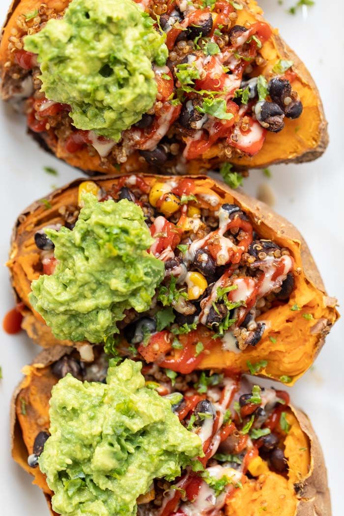 baked sweet potatoes topped with guacamole and black beans