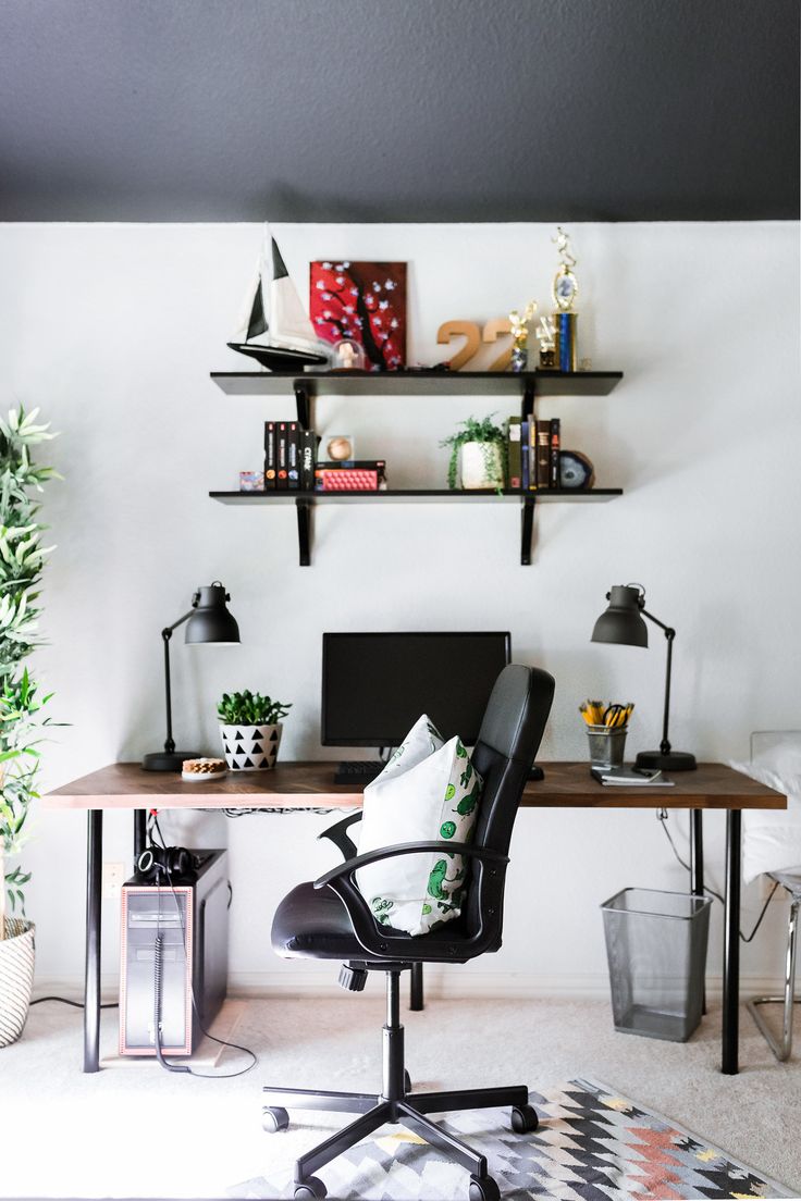 an image of a desk chair in the middle of a room with shelves above it