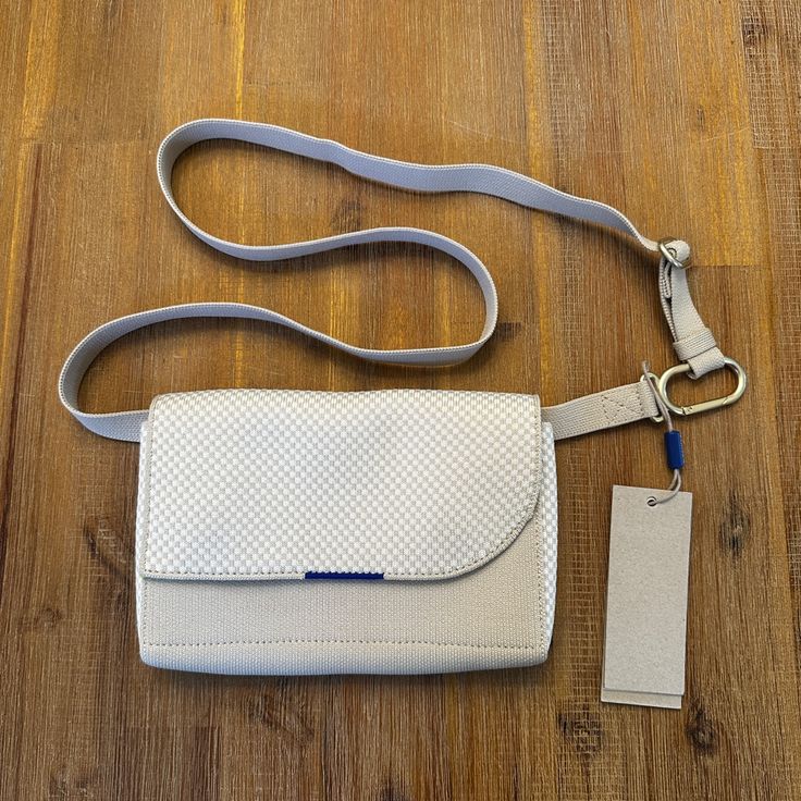 New With Tag Rothy’s Belt Bag White Flap Bag For Travel With Dust Bag, White Clutch Flap Bag With Dust Bag, White Crossbody Shoulder Bag With Magnetic Closure, White Textured Leather Crossbody Shoulder Bag, White Leather Shoulder Bag With Magnetic Closure, White Crossbody Belt Bag For Daily Use, White Everyday Pouch Belt Bag, White Rectangular Belt Bag For Everyday Use, White Textured Leather Travel Satchel