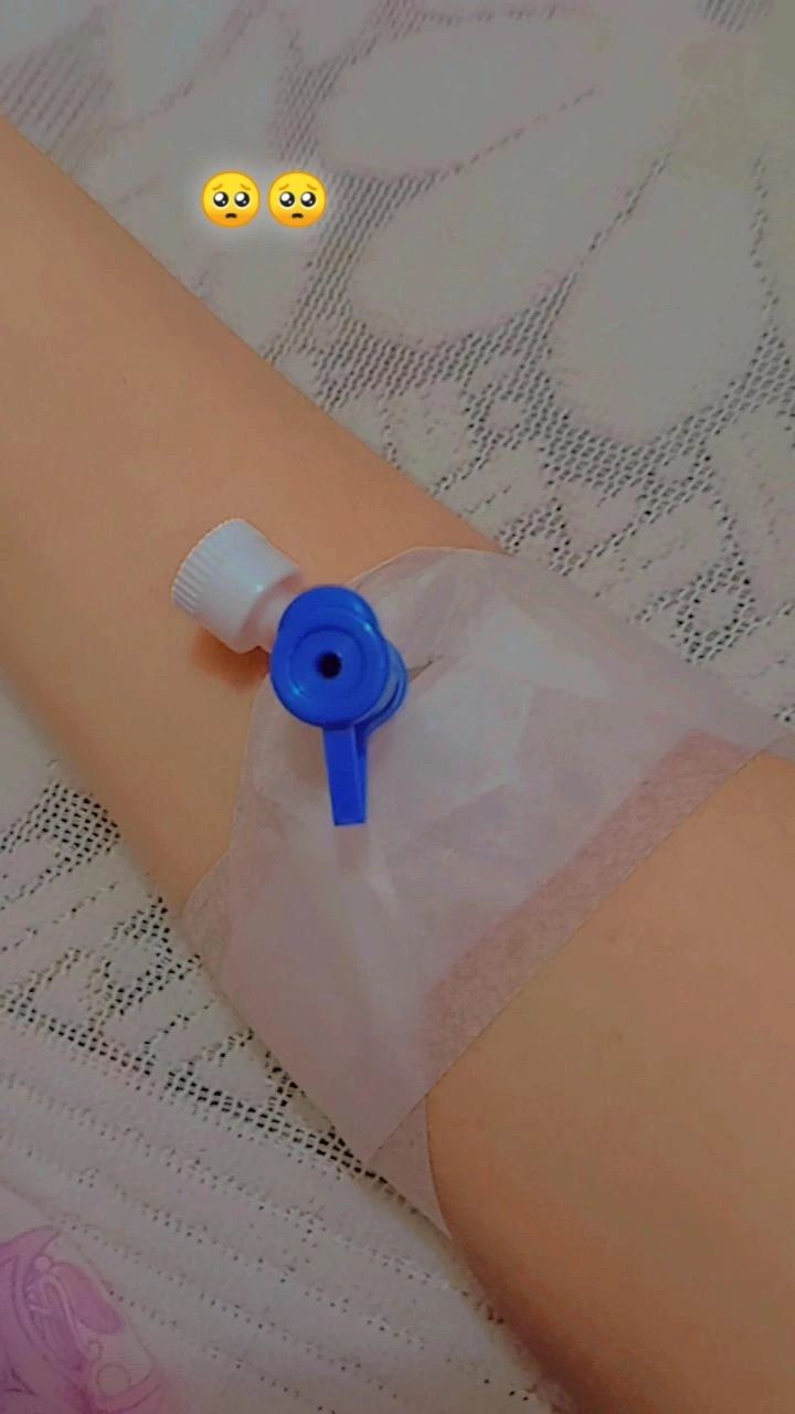 a woman's arm with an inhaler attached to it and two smiley faces drawn on the background