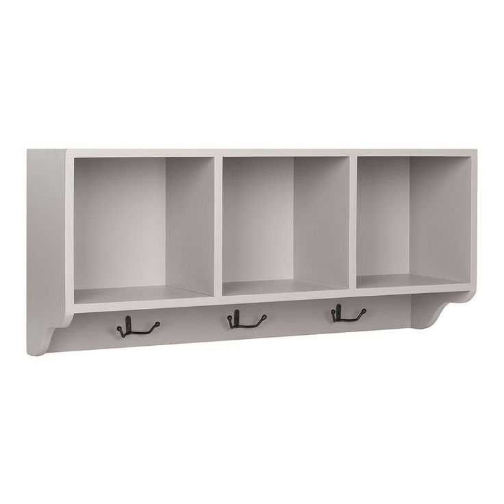 a white shelf with three hooks and two shelves on each side, in front of a white wall