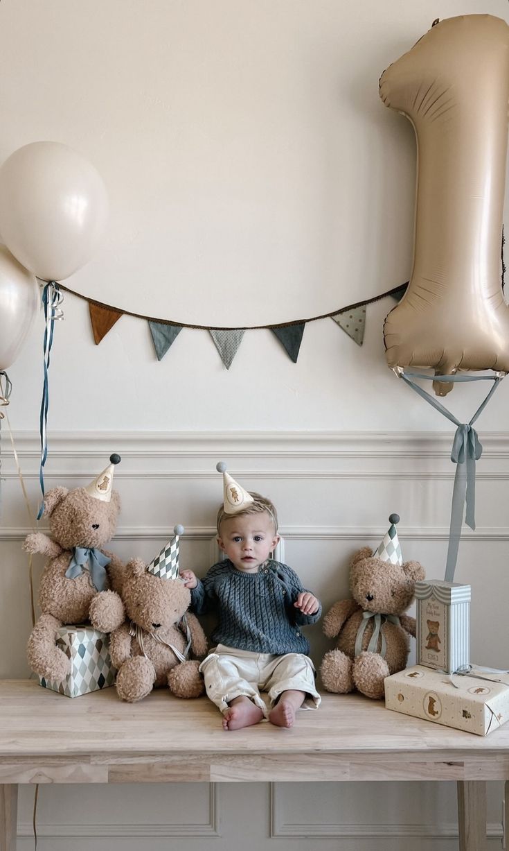 a baby is sitting on a table surrounded by balloons and teddy bears in front of him