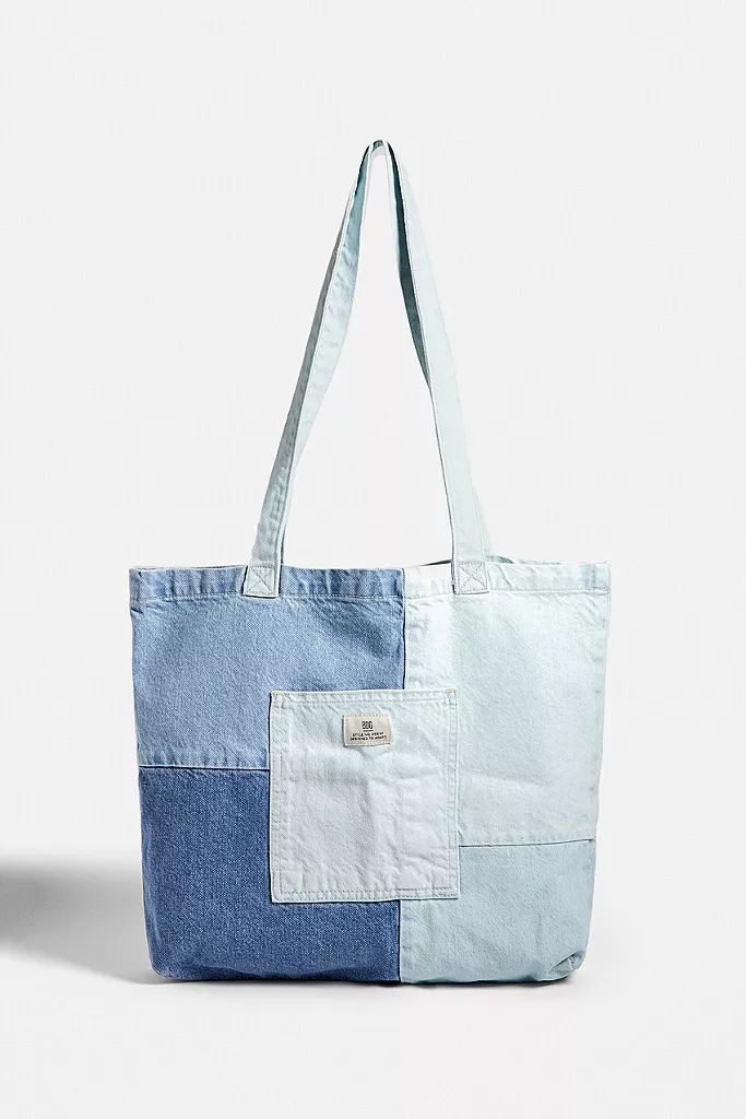 a blue and white tote bag sitting on top of a table