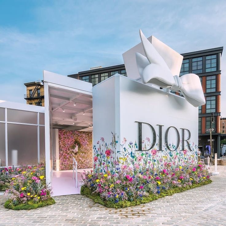 the entrance to dior is decorated with flowers