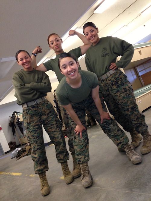 four women in army fatigues posing for a photo