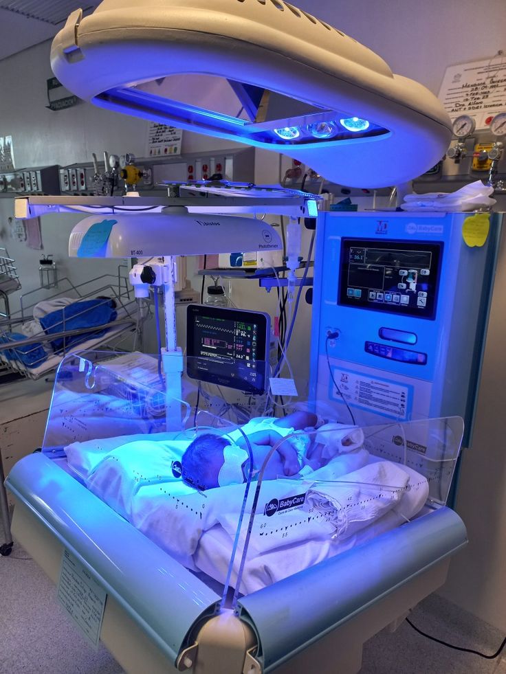 a hospital room with neon lights and medical equipment