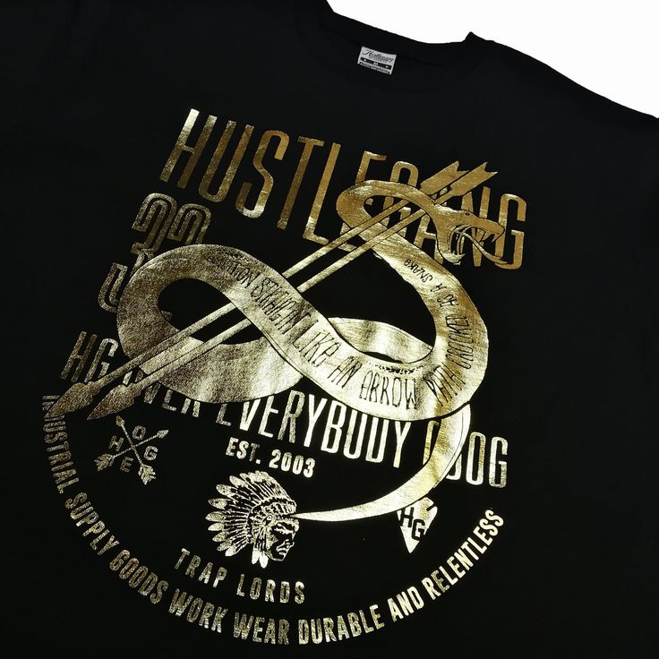 Hustle Gang Viper logo tee features premium 100% cotton crewneck t-shirt with gold foil logo screen-print at front. By Hustle Gang of America. Style: HG1810709 Gold Graphic Tee With Crew Neck, Gold T-shirt With Screen Print, Short Sleeve, Gold Short Sleeve T-shirt With Direct Printing, Gold Short Sleeve T-shirt With Screen Print, Gold Graphic Tee With Short Sleeves, Gold Short Sleeve Graphic Tee, Gold Crew Neck T-shirt With Screen Print, Gold Crew Neck T-shirt With Letter Print, Gold Cotton Tops With Logo Print