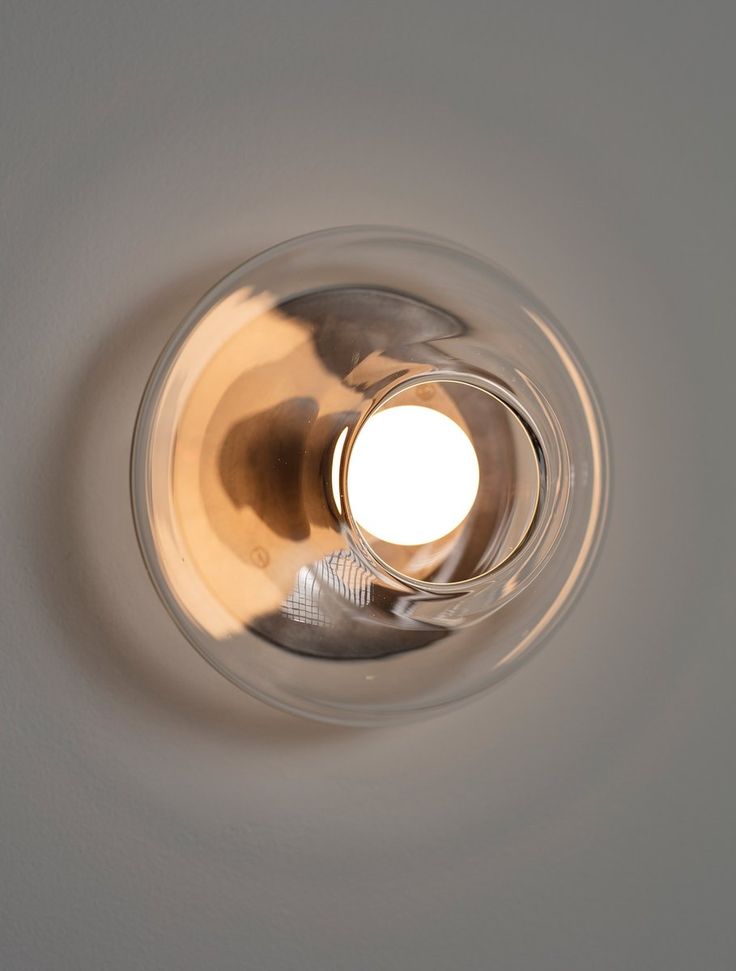 an overhead view of a light fixture in a room with white walls and flooring