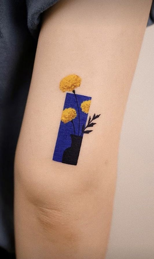 a woman's arm with yellow flowers on it