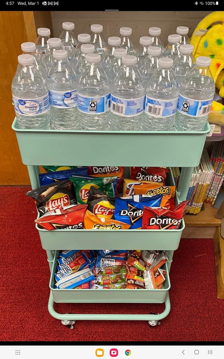 a cart filled with lots of bottled water on top of a red carpeted floor