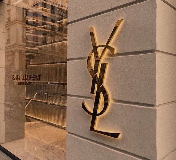 a sign on the side of a building that says ysl