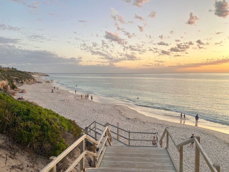 stairs lead down to the beach at sunset