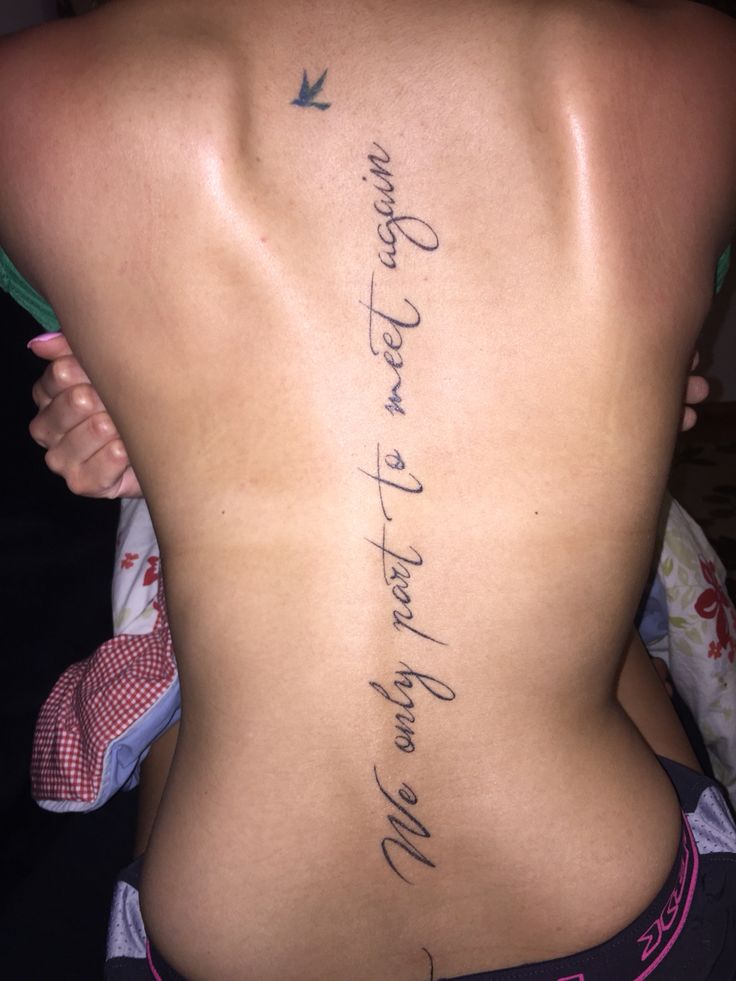 the back of a woman's body with writing on it