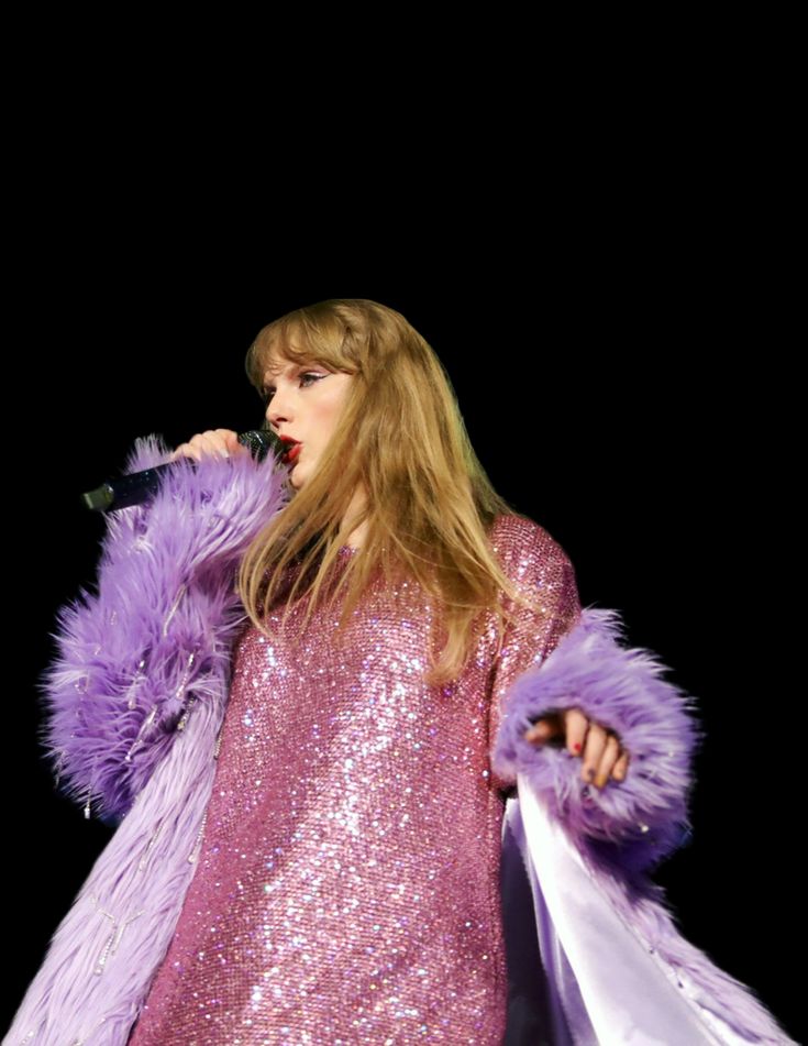 a woman with long hair and purple dress on stage