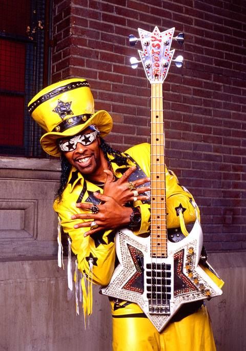 a man dressed in yellow holding a guitar