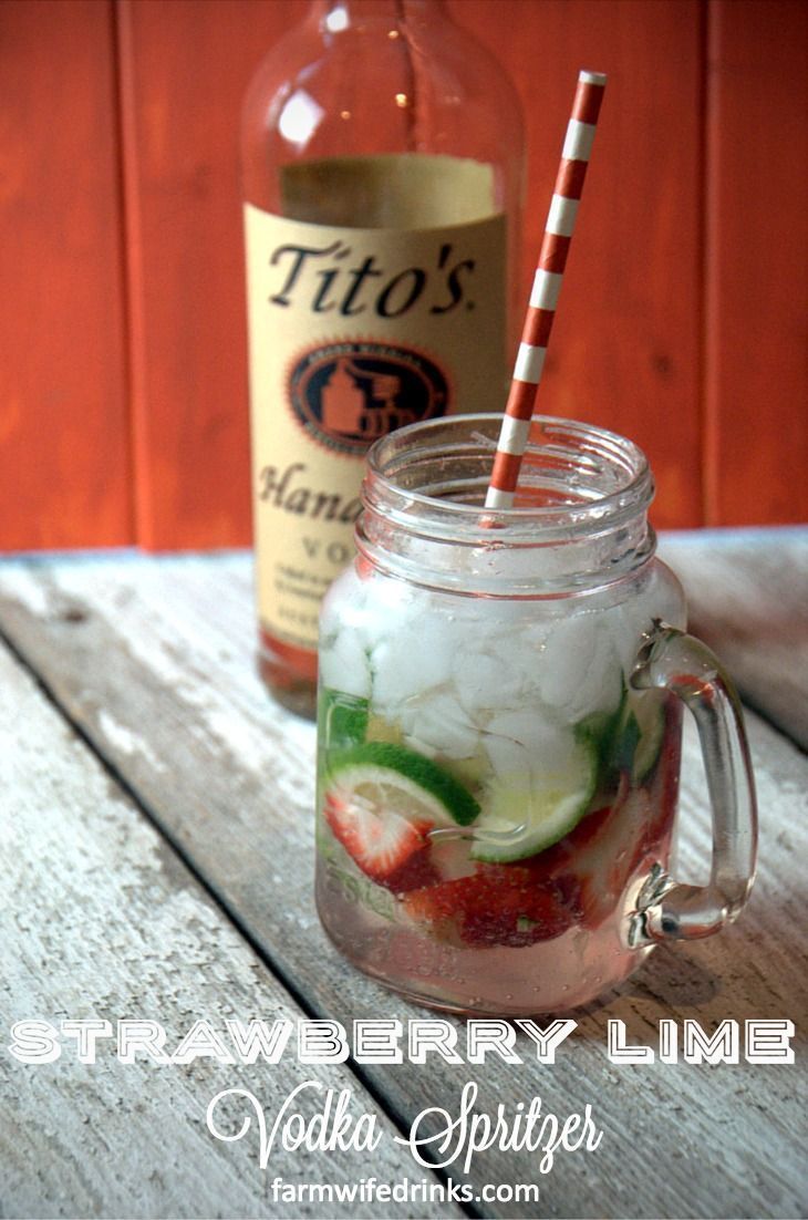 a mason jar with strawberries and cucumber in it next to a bottle