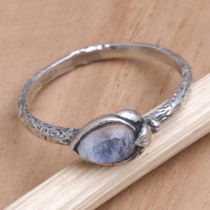 Perfect for everyday wear Putu Putri's pretty ring features an iridescent moonstone that glows with unrivaled mystery. Balinese artisans hand craft the ring from sterling silver centering the accessory with a smooth moonstone in a gleaming bezel setting. Silver Moonstone Stackable Rings With Birthstone, Silver Moonstone Ring With Nature-inspired Style, Adjustable Mystical Moonstone Promise Ring, Mystical Sterling Silver Moonstone Birthstone Ring, Adjustable Moonstone Stackable Rings, Mystical Sterling Silver Moonstone Promise Ring, Silver Nature-inspired Moonstone Ring, Unique Adjustable Moonstone Birthstone Ring, Handmade Moonstone Promise Ring