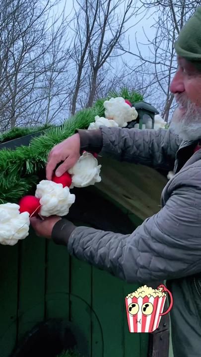 a man is placing flowers in the back of a truck