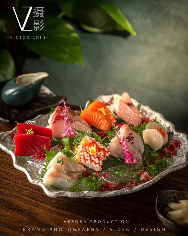 a platter filled with sushi on top of a wooden table