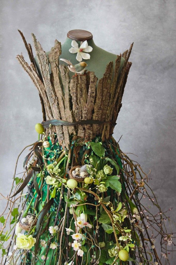 a mannequin made out of branches and flowers