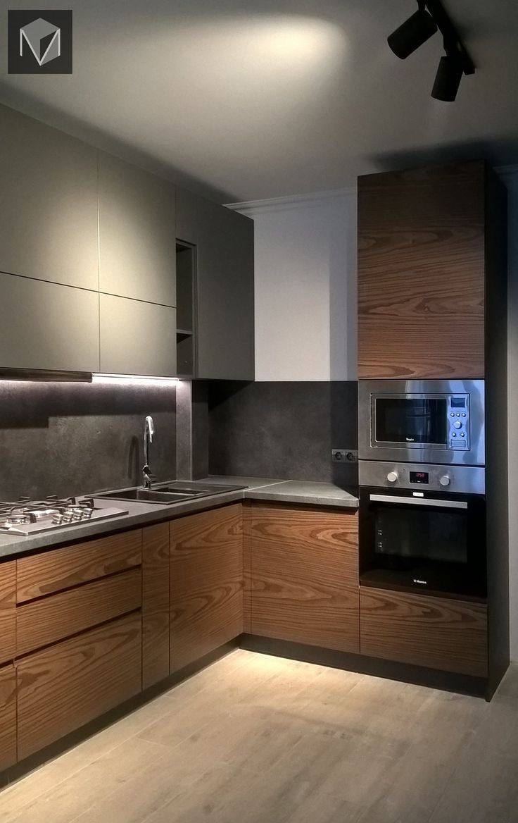 a modern kitchen with wood cabinets and stainless steel appliances