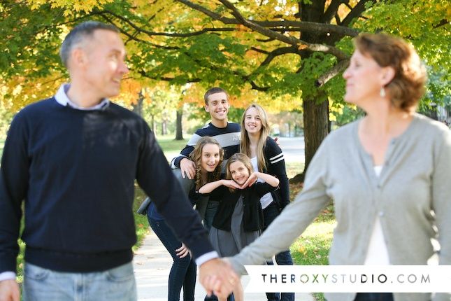 a group of people standing around each other holding hands