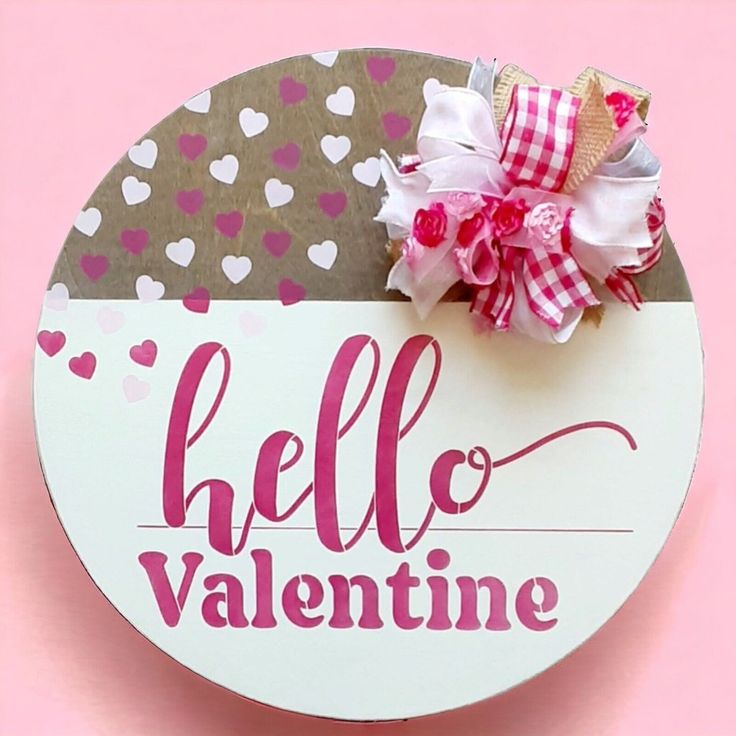 a hello valentine sign with a bow on it