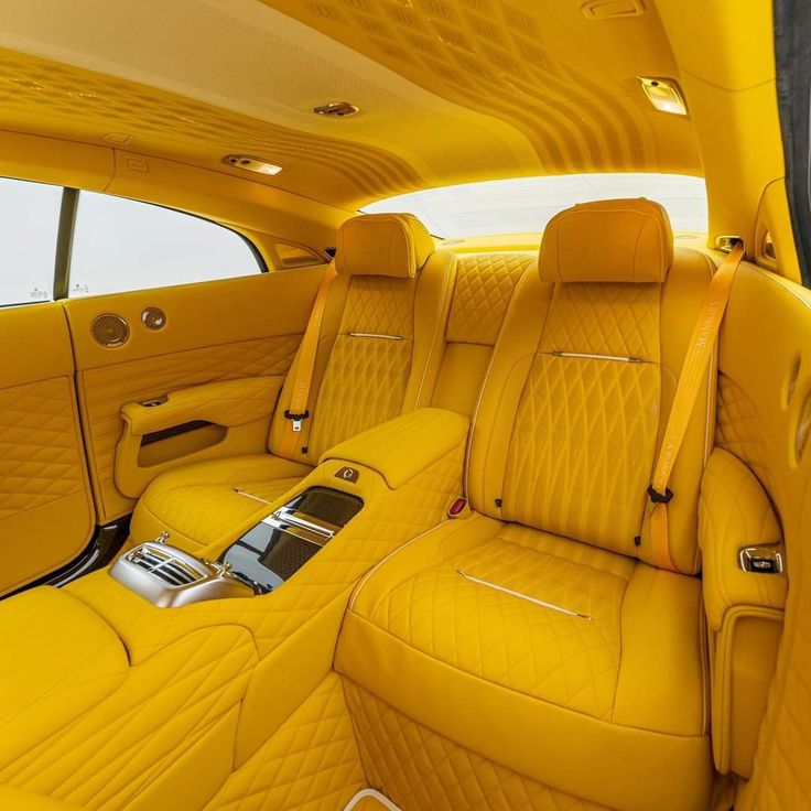 the interior of a car with yellow leather