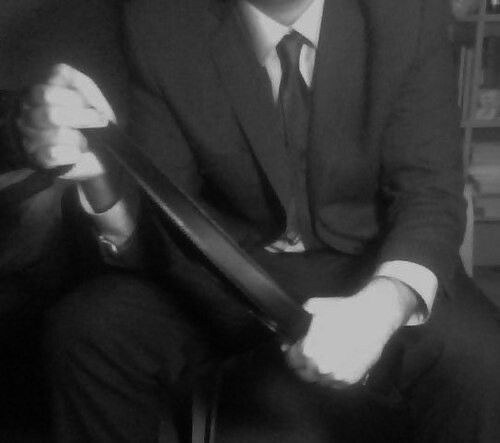 a man in a suit and tie sitting down