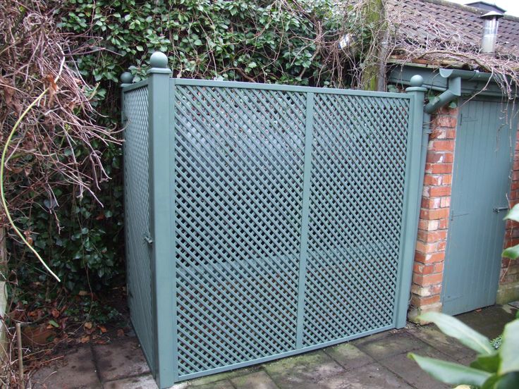 an iron gate in front of a brick wall with vines growing on the sides and behind it