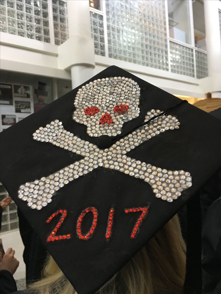 a decorated graduation cap with a skull and cross bones on it