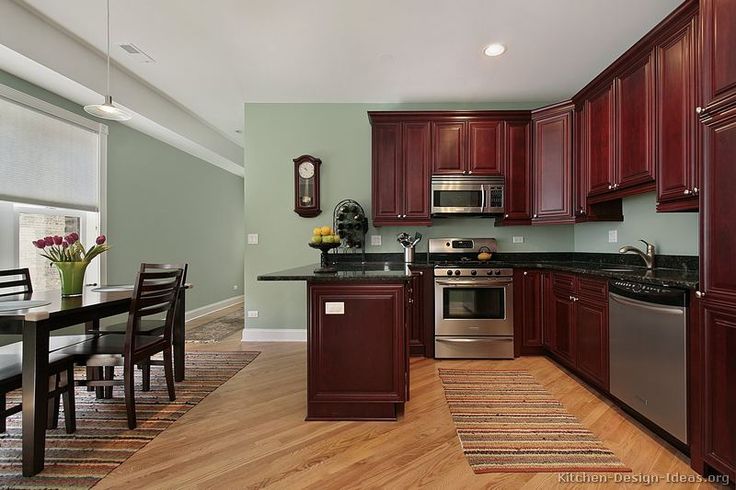 a kitchen with wooden cabinets and stainless steel appliances