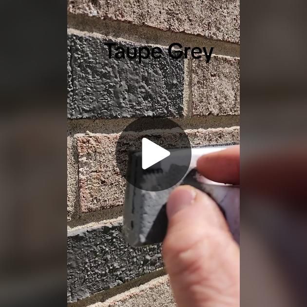 a hand is pointing at a brick wall with the words tapple grey on it