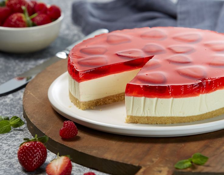 a cheesecake with strawberry topping on a white plate