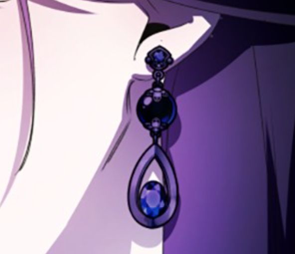 a close up of a person wearing earrings with purple and blue beads hanging from them