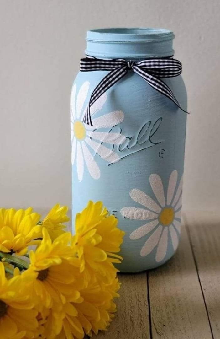 some yellow flowers and a blue mason jar