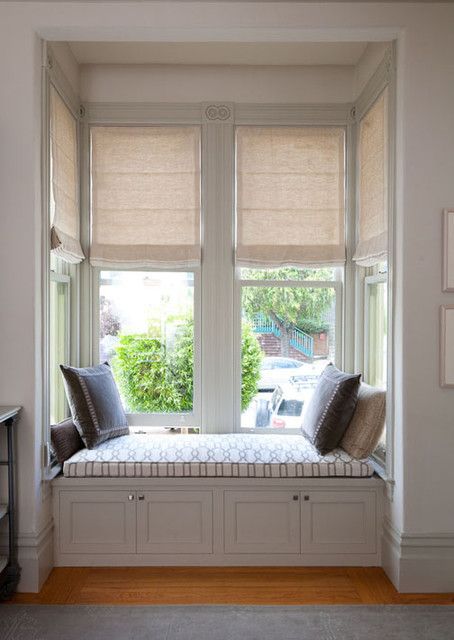 a window seat with two pillows on it