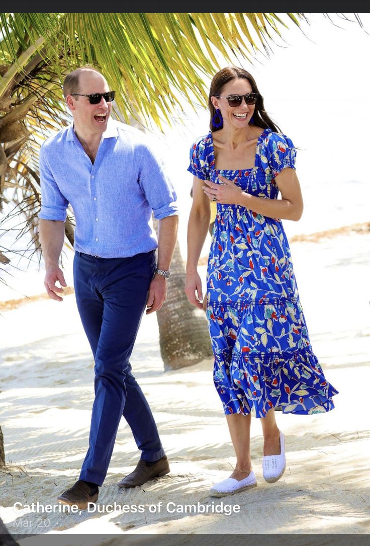 a man and woman walking on the beach