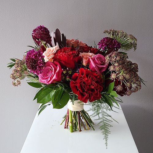 a bouquet of flowers sitting on top of a white table