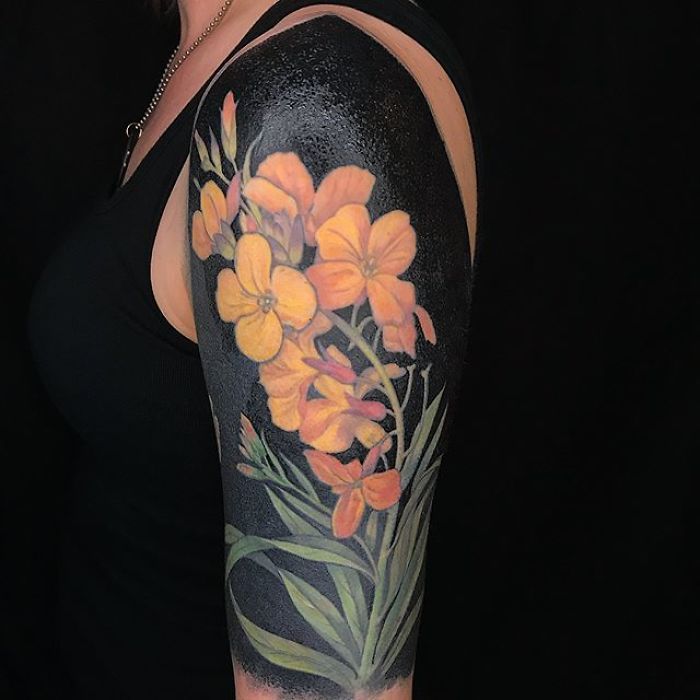 a woman's arm with flowers painted on it