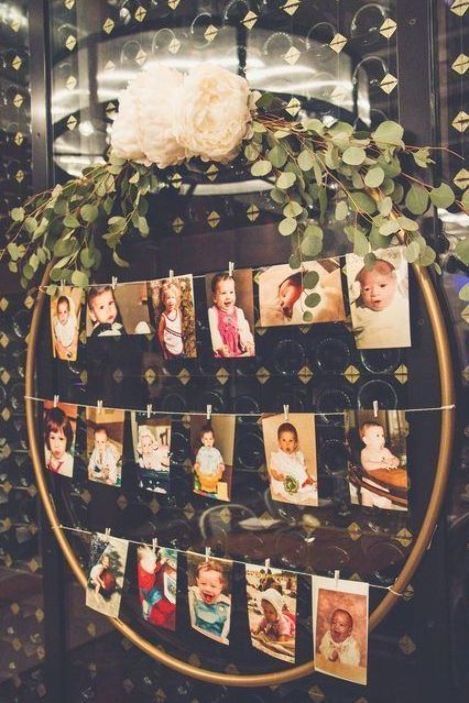 a bunch of pictures hanging on a clothes line with flowers and greenery in the background