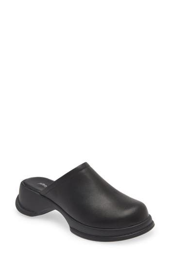 A sculpted rubber sole enhances the cushioned comfort of this shapely clog constructed from smooth leather. 2" heel; 3/4" platform (size 8.5) Leather upper and lining/rubber sole Imported Synthetic Clogs With Rubber Sole, Black Mules With Arch Support, Slip-on Closed Toe Synthetic Clogs, Black Leather Clogs With Arch Support, Slip-on Synthetic Closed Toe Clogs, Slip-on Synthetic Clogs With Closed Toe, Modern Clogs With Cushioned Footbed For Work, Modern Synthetic Clogs With Rubber Sole, Modern Synthetic Clogs With Round Toe