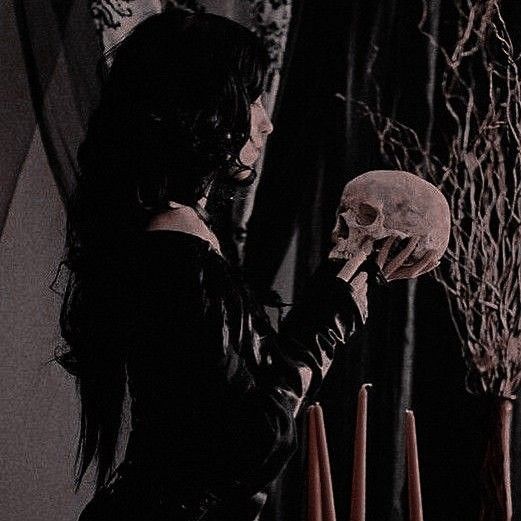 a woman holding a skull in her hand