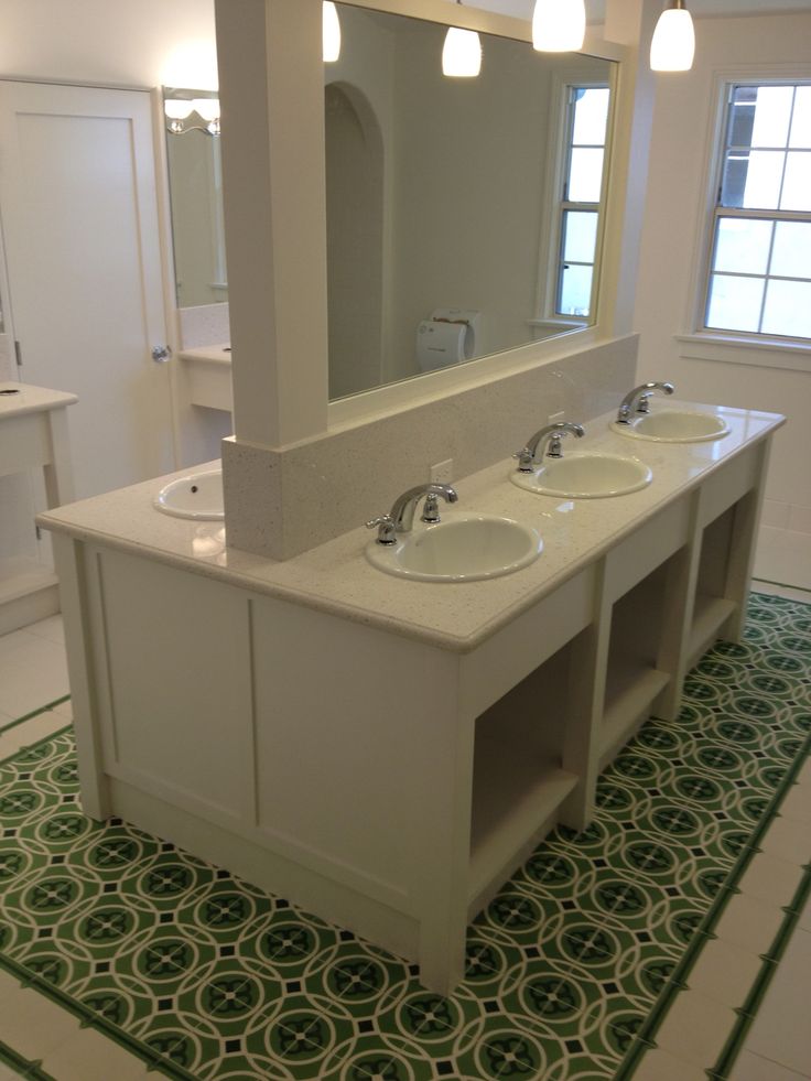 a bathroom with two sinks and a large mirror