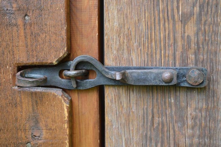 an old metal latch on a wooden door