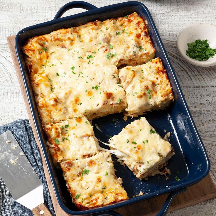 a casserole dish with cheese and meat in it