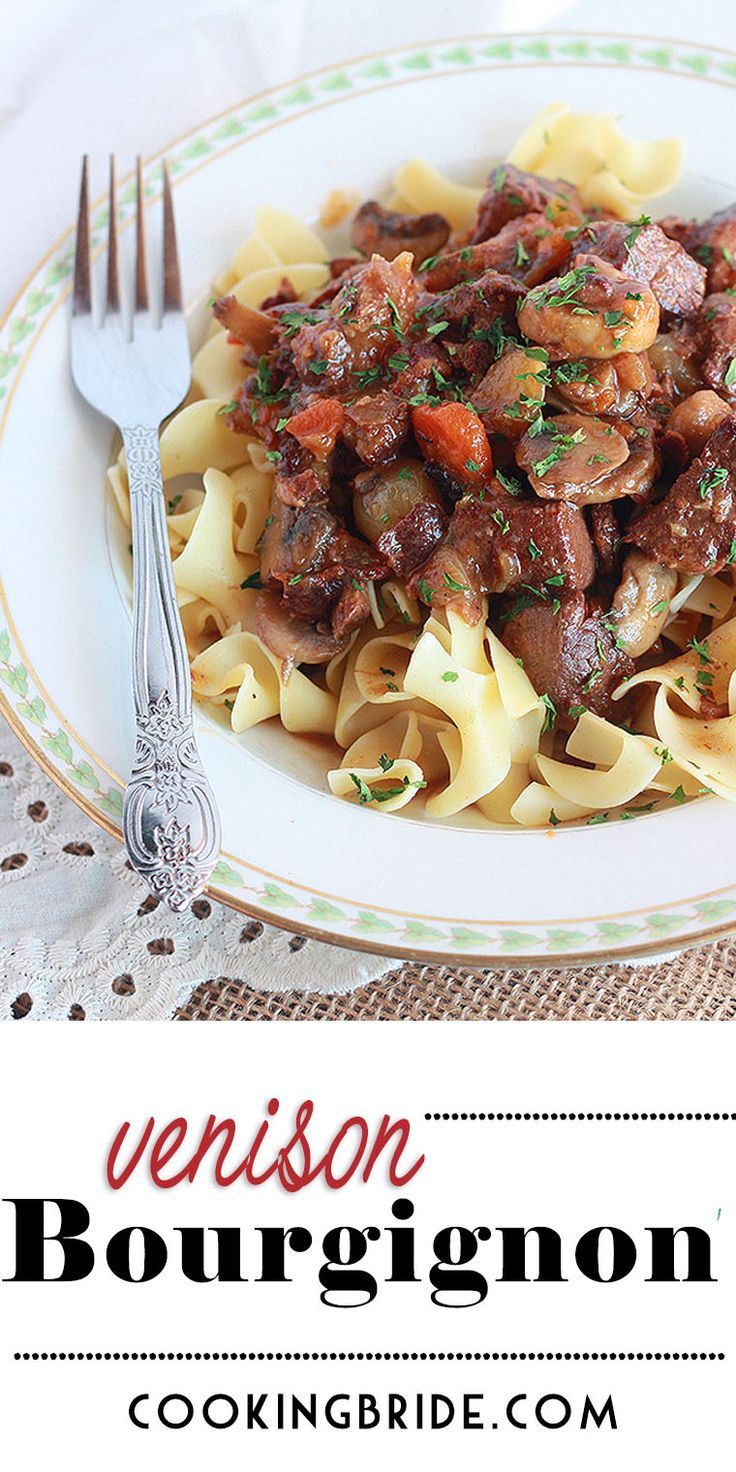 a white plate topped with pasta and meat